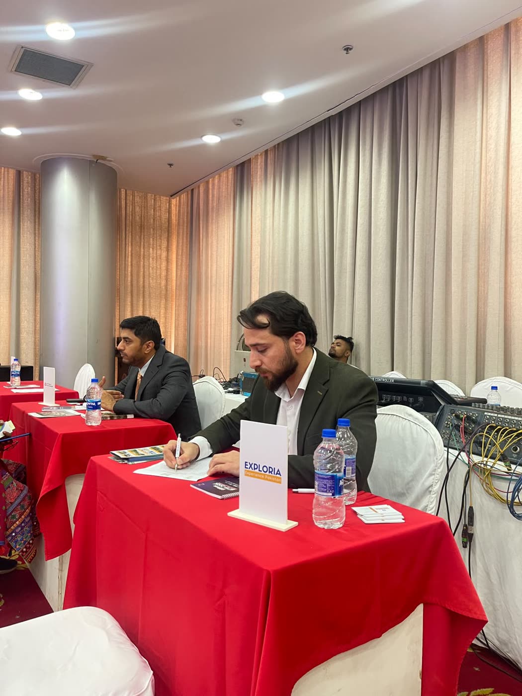 Arif Hussain at a B2B table with an Exploria name card