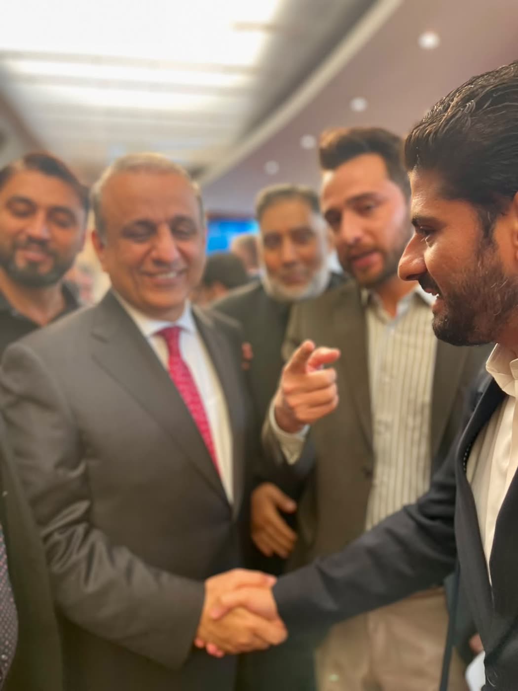 Delegates shaking hands at an event