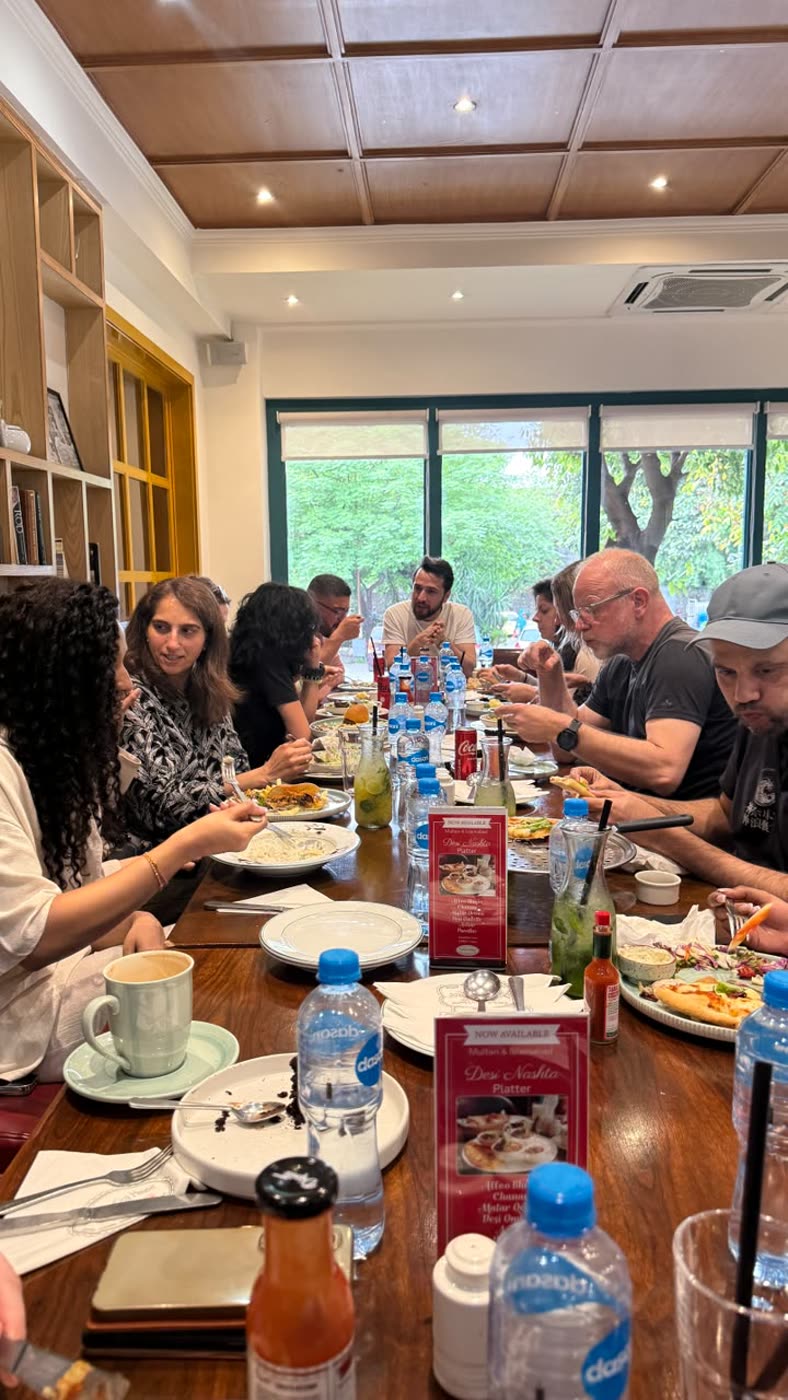 A long dinner table with international guests