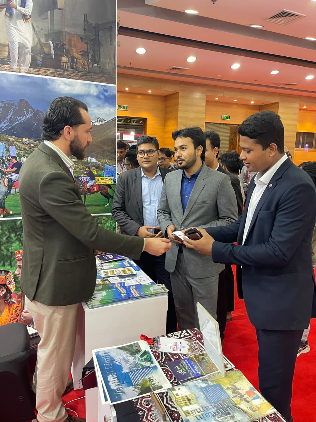 Arif Hussain exchanging business cards with visitors at the Pakistan stand