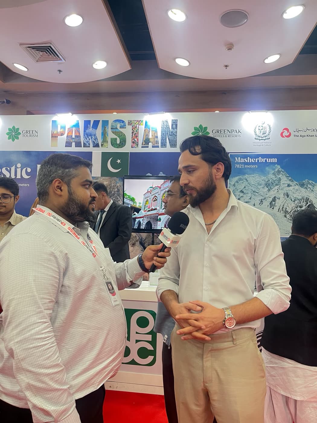 Arif Hussain giving a media interview at the Pakistan pavilion